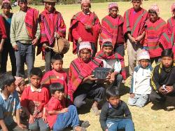 Quechua villagers pose with a Proclaimer- a solar powered Audio Bible